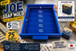 A blue rectangular Joe Soap Mold tray shown on a styled tabletop with soap bars, measurement callouts, and promotional text. The mold is labeled for 15-inch dimensions and can hold 15 bars of soap, with a reference bar and Canadian-made badge visible.