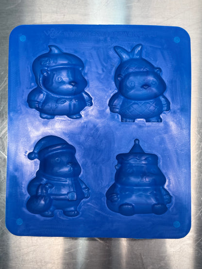 Blue silicone mold with capybara character shapes on a metallic surface