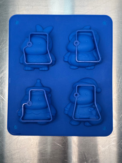 Blue silicone mold with capybara character shapes on a metallic surface