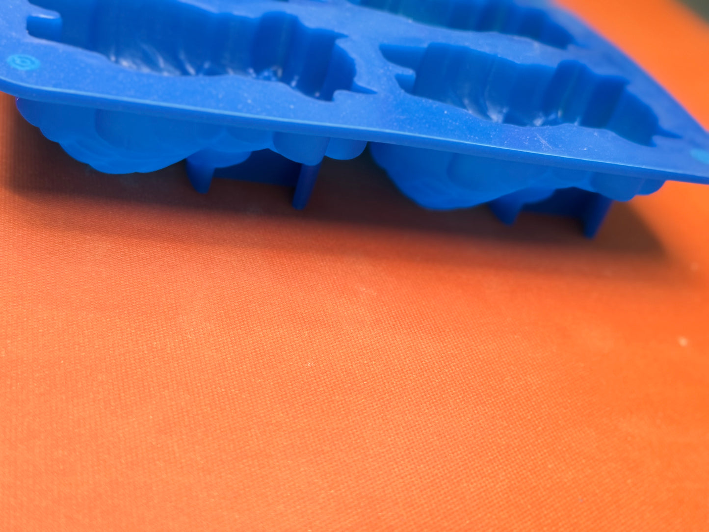 Blue silicone mold on an orange surface