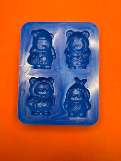 Blue silicone bear-shaped mold on an orange background