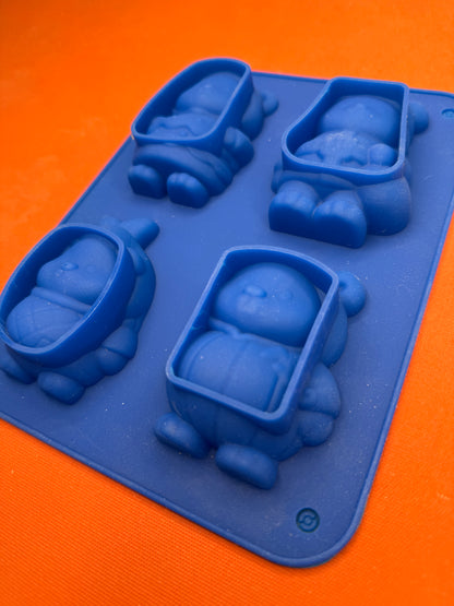 Blue silicone mold with various shapes on an orange background