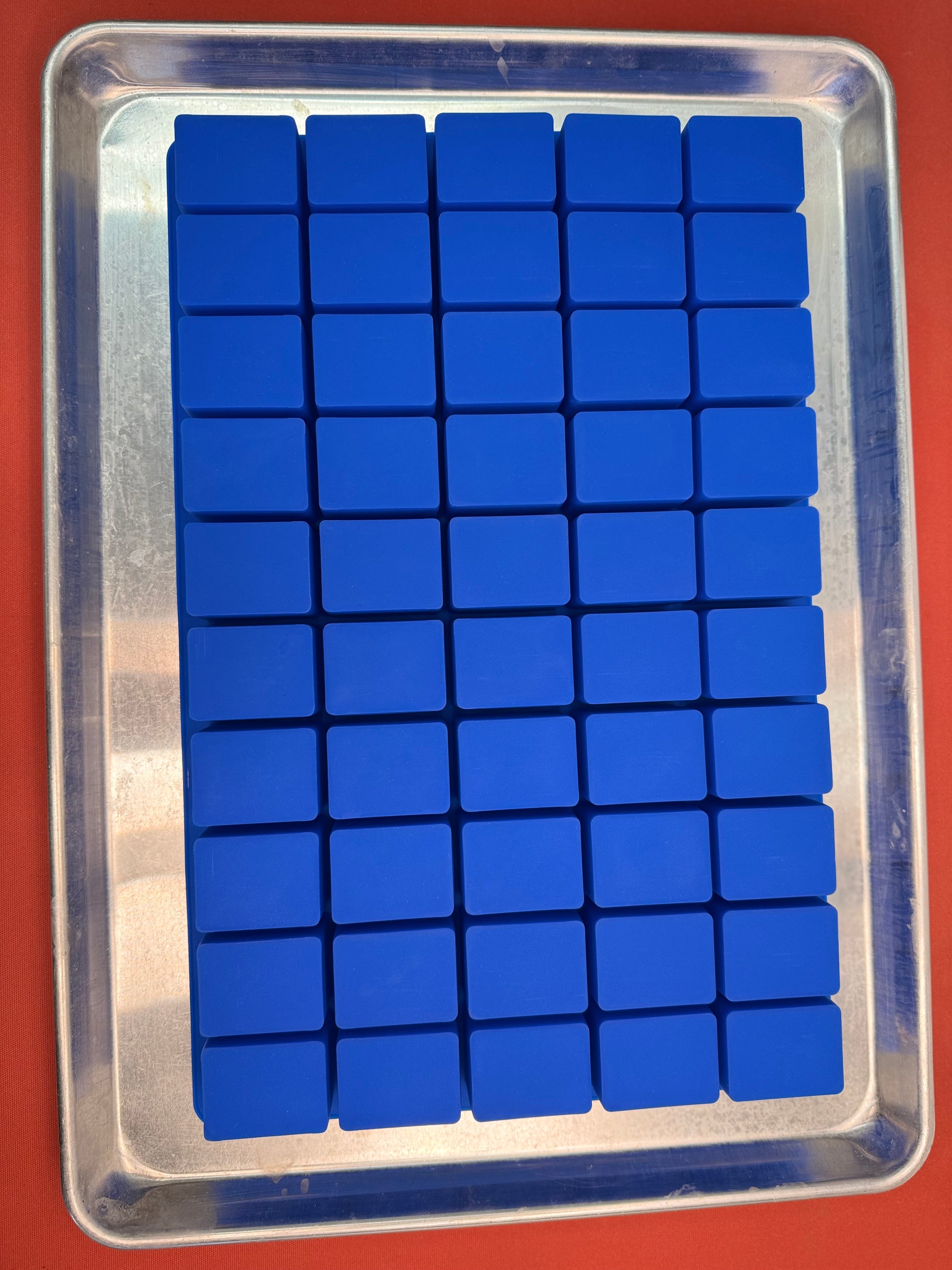 Blue silicone rectangle mold on a baking tray. 