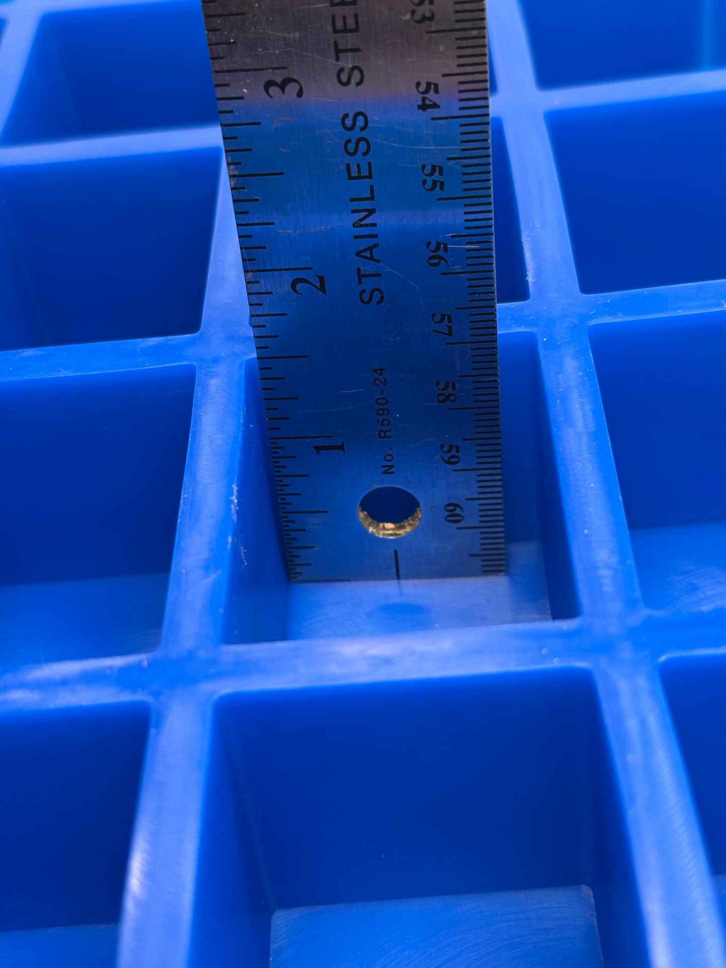 Metal ruler on a blue silicone mold 